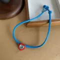 Stylish blue leather cord necklace featuring a red heart pendant with crystal center - Heart