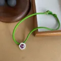 Vibrant green leather cord choker featuring a purple crystal flower pendant detail. - Colorful Floral