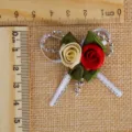 Detailed view of handmade satin rose bow with silver beads for elegant gift wrapping - 5x4cm / Red