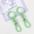 Close-up detail of light green metal spring keychain and carabiner ring with smooth paint. - 10 Green