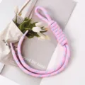 Detail view of hand-woven pink braided rope bag charm and phone lanyard accessory - 29# Taro Pink with Blue