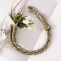 Detailed view of a handcrafted khaki braided rope bag charm with decorative white accents - 40# Dark Khaki with White