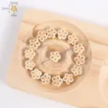 Detailed view of carved lotus flower bodhi root loose beads arranged neatly on a wooden tray. - 10# White Small Plum Blossom