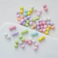Close-up view of colorful peanut-shaped DIY craft beads, ideal for custom accessories and jewelry. - 30# Bone