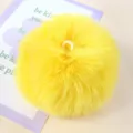 Close-up detail of a bright yellow fluffy faux fur pom pom with hanging loop, soft DIY decor. - 04# Bright Yellow
