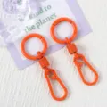 Orange metal spring keychain and carabiner set, durable baking paint bag accessory. - Orange