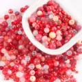 Close-up macro view of 20g mixed red and pink glass beads for DIY jewelry making projects - 20.00g / 06