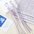 Detailed view of hand-woven purple and white nylon rope bag charms with tassel ends - 1 Piece/Pack / 01# Cream White + Purple