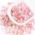Detailed top-down view of various mixed pink glass and stone beads for DIY jewelry making - 20.00g / 04