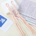 Close-up detail of handmade pink and white bicolor woven nylon rope bag charm pendant. - 1 Piece / 07# Cream White + Snow Bud