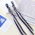 Close-up view of two bicolor purple and black braided nylon rope bag charms for DIY accessories - 1 Piece / 15# Black Dots + Light Purple Dots