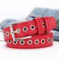 Primer plano de cinturón punk rojo con ojales metálicos plateados y hebilla de pasador - 105cm / Rojo