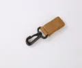 Clip portachiavi tattico in nylon da esterno con moschettone in plastica nera. - Kaki