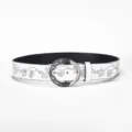 Close-up of a white vintage leather belt with floral embossing and round silver buckle. - 110cm / White