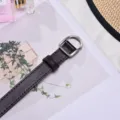 Elegant thin dark brown PU leather belt featuring a silver D-shaped metal buckle for ladies - Coffee