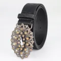 Vintage black leather belt featuring floral embossing and ornate rhinestone buckle - Black / 110cm