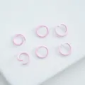 Detailed macro view of small pink matte coated alloy open jump rings for jewelry DIY. - 6mm (100pcs) / Light Pink