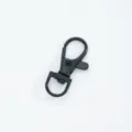 Macro view of a durable black metal swivel lobster clasp for bag hardware accessories - Bright Black
