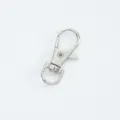 Detailed macro view of a silver alloy lobster swivel clasp for bag and key accessories - Bright Silver