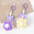 Close-up of two cute handmade beaded flower plush ball keychains in purple and yellow - 1 Piece / Yellow + Purple