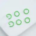 Macro view of lime green painted alloy jump rings for handmade DIY jewelry crafting - 6mm (100pcs) / Green