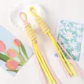 Detail view of colorful hand-woven phone lanyards featuring a pink and yellow Roma knot - 1 Piece / Light Yellow + Light Pink