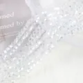 Detailed macro view of 4mm AB iridescent crystal bicone beads with brilliant sparkle - 4mm Approx 70 Pieces/Strand / White AB