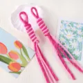 Macro detail shot of two pink handmade braided lanyards with decorative Roman knot patterns - 1 Piece / Rose Red Dot + Pink Dot