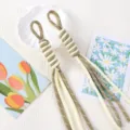 Detail of two-tone hand-woven Roman knot tassels for keychains, bags, or DIY crafts - 1 Piece / Beige + Khaki Dot
