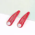 Detailansicht roter Tropfenhaarspangen mit weißen Polstern, glänzendes Haaraccessoire. - 10er Pack / 17 Rot