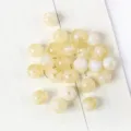 Macro detail of pearlescent yellow acrylic cat-eye beads for DIY jewelry making - 15 (Yellow and White Cat Eye Marble)
