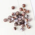 Detail macro view of brown and white marbled acrylic cat eye beads for jewelry making - 10mm (50 pcs) / 03 (Dark Brown Faux Cat's Eye Pattern)