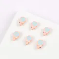 Close-up of cute alloy painted cartoon lollipop beads in pink and blue for DIY jewelry making. - 08