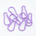 Detailansicht mehrerer lila lackierter birnenförmiger Karabiner-Federverschlüsse - 1 Stück/Packung / Lila