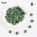 Close-up of green kiln-glazed ceramic snail beads with dimensions 11x13mm for DIY - Snail Style (10#)