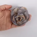 Detailed view of a 7.5cm chiffon burnt-edge rose flower accessory held in a person's hand - Gray