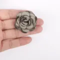 Detailed view of handmade burnt edge fabric rose flower for DIY crafts - Green