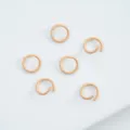 Close-up of light orange enamel jump rings for handmade DIY jewelry making projects - 6mm (100pcs) / Light Orange