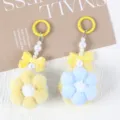 Detail view showing handmade plush flower pom-pom pendants in soft yellow and blue colors. - 1 Piece / Yellow + Blue