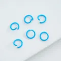 Macro view of light blue painted alloy open jump rings for DIY jewelry. - 6mm (100pcs) / Sky Blue