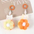 Close-up of cute handmade pom-pom flower keychains with pearls and bows for bags and phones - 1 Piece / Yellow + Orange