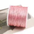 Close-up detail of pink DIY crafting cord with shimmering gold threads, ideal for handmade crafts. - Light Pink