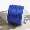 Detailed close-up of royal blue jade cord with gold glitter thread, wound neatly on spool. - 24# Royal Blue