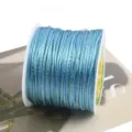 Detailed view of light blue nylon cord with gold thread for DIY craft weaving spool - 27# Sky Blue