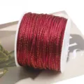 Close-up detail of red and gold DIY weaving cord wound on white spool, ideal for crafts. - 90m/Roll / 29# Wine Red