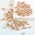 Close-up view of shiny metallic gold square CCB spacer beads for DIY necklace craft. - 3mm (200 Pieces) / KC Gold