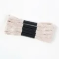 Macro detail of cream-colored six-strand polyester embroidery thread bundles on white fabric - 5 Pcs Set / Off White