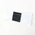 Detail view of five bundles of high-quality white embroidery floss with black paper sleeves - 5 Pcs Set / White