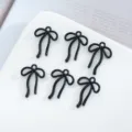 Dettagli di ciondoli fiocco nero in lega, perfetti per gioielli fai da te e bracciali. - 10 Pezzi/Confezione / Nero