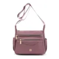 Front view of a purple multi-compartment nylon shoulder bag with adjustable strap - Pink
